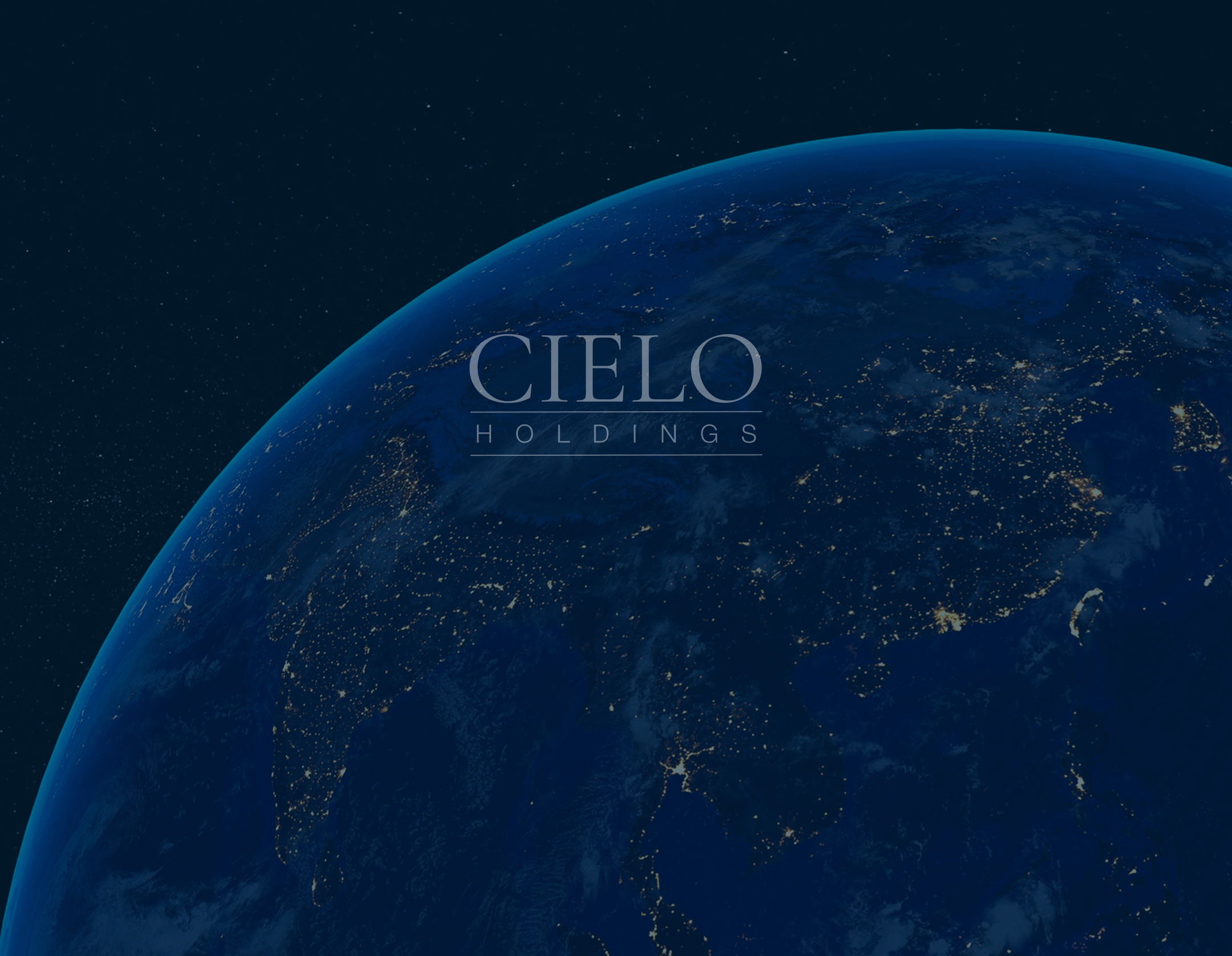 Two women sitting at a modern table talking with a city view behind them.